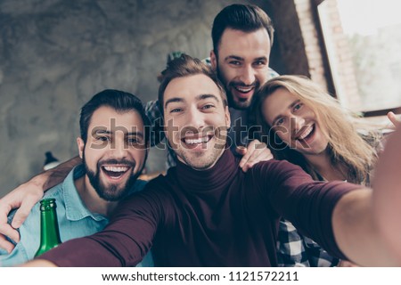 Self portrait of four attractive, confident, successful, funny guys with modern hairstyle making selfie with two hands on mobile phone, front camera, community spending great time