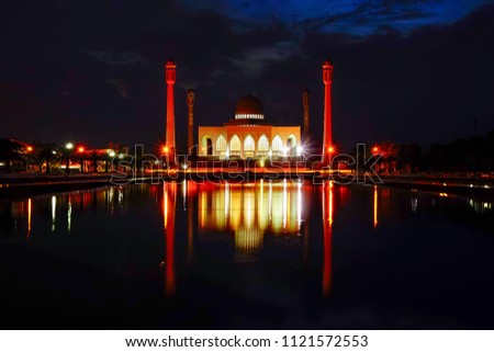 Beautiful reflection over central mosque in Songkhla province, Thailand. Image contains grain and soft focus.