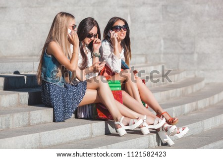 Pretty girlfriends making selfie and talking on cell phone