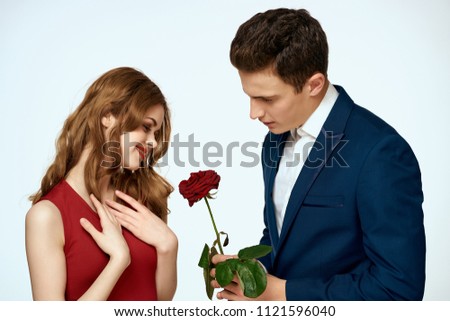 young man in a suit gave a woman a flower                     