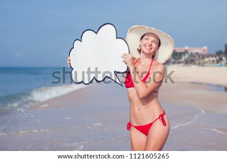 A pretty girl in bikini with bubble speech in hands on the beach