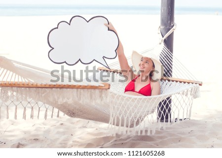 Cloud storage, travel, summer concept. Woman in bikini holding paper cloud icon on the hammock.