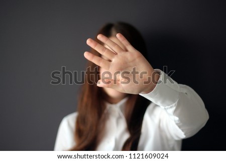 Woman's hand showing reject or stop gesture. Woman Closes the Face with Her Hand