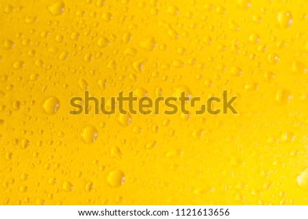 Water drops on yellow background.Macro shot of water drop on yellow background.