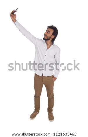 man taking selfie in casual wear in full length shot , isolated in white background Royalty-Free Stock Photo #1121633465