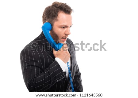 Portrait of business man talking on blue telephone receiver isolated on white background with copyspace advertising area