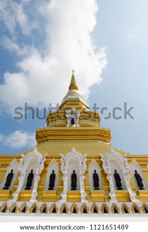 Here is a picture of one beautiful Pagoda in Temple with a clear sky and some of clouds at Chiangrai, Thailand