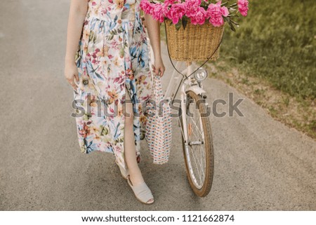 Bicycle with flowers in the basket. The image is suitable for use as a background image or as an emotional image. This image has a retro feel because it uses film tones