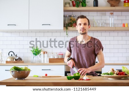 Photo of man cooking vegetables on table