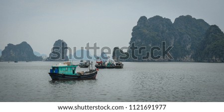 Wooden boats on the sea in Ha Long, Vietnam. Ha Long Bay is a UNESCO Site and popular travel destination.
