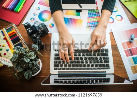 Professional Asian women Graphic designer using graphics tablet to do his work at desk. Architectural drawing with work tools and accessories.