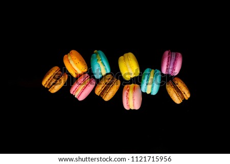 colorfull macarons black background,  flat lay   .pink color and ment color macaroons.top view.copy paste