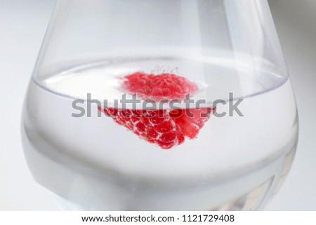 Fresh raspberries in a glass. A close-up.