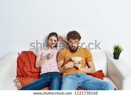 young couple sitting on the couch                               