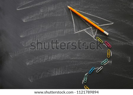 Top view image of sketch plane over classroom blackboard background