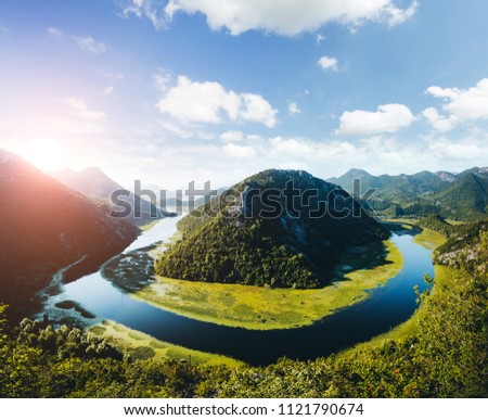 Aerial view of Rijeka Crnojevica flowing through mountains. Location National park Skadar Lake, Montenegro, Balkans, Europe. Scenic image of popular travel destination. Discover the beauty of earth.