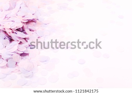 Pink pastel confetti on white background. Festive backdrop for your design.