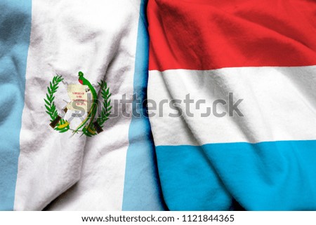 Guatemala and Luxembourg flag on cloth texture
