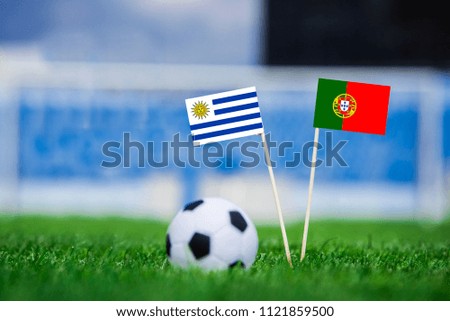 Uruguay and Portugal national Flag on green grass, round of 16