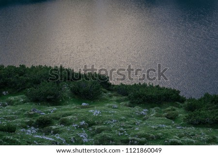 Sunset reflecting in austrian alp lake Drachensee
