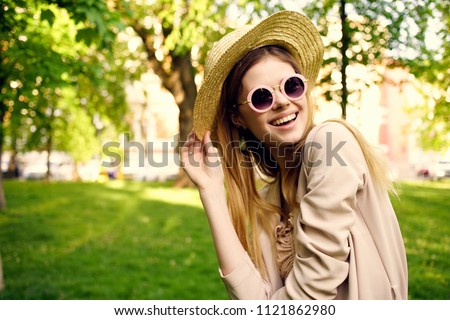  woman in a hat smiling street                              