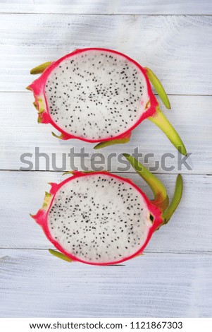 Dragon fruit on old wooden background.