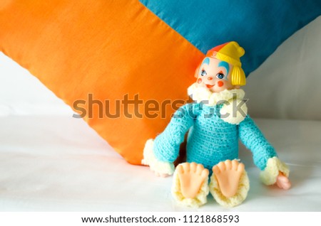 colorful clown doll lay down on the bed