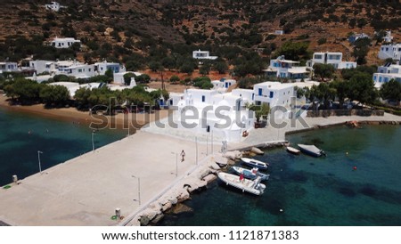 Aerial drone bird's eye view photo from famous and picturesque bay and fishing village of Vathi with iconic whitewashed church of Taxiarhis and turquoise clear waters, Sifnos island, Cyclades, Greece