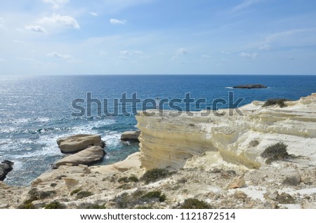 Travel woman, wanderlust concept. Woman near sea standing on a cliff. Woman on white mountain in Cyprus, Mediterranean Sea
