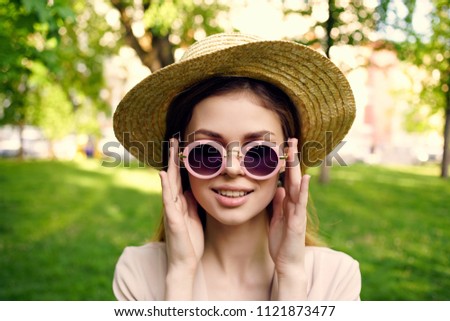 a woman fixes glasses on her face                              