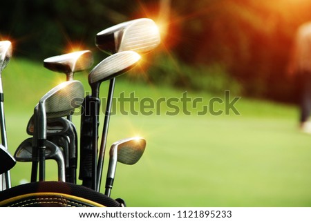 Golf equipment in beautiful golf course at sunset background.