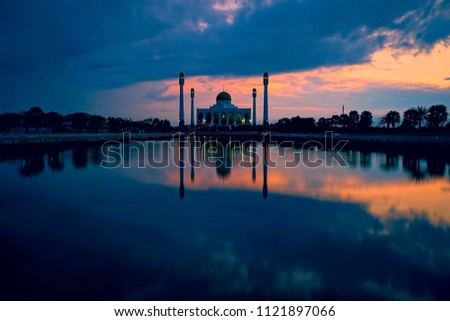 Beautiful sunset at the central mosque in Songkhla province, Thailand. Image contains grain and soft focus.