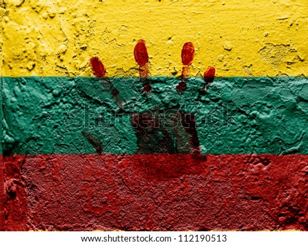 The Lithuanian flag painted on grunge wall with bloody palmprint over it