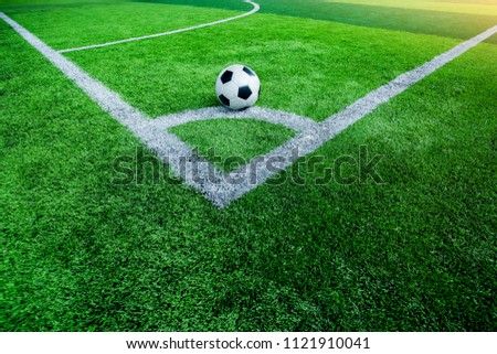 Ball on artificial turf at corner of football field.