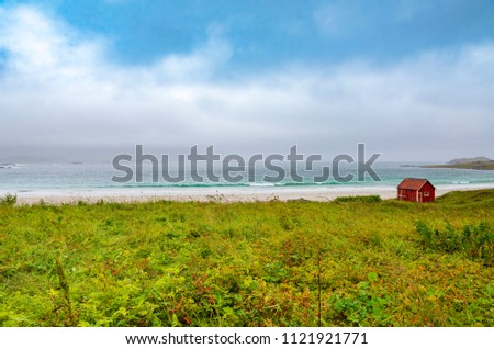 Red cottage by the sea