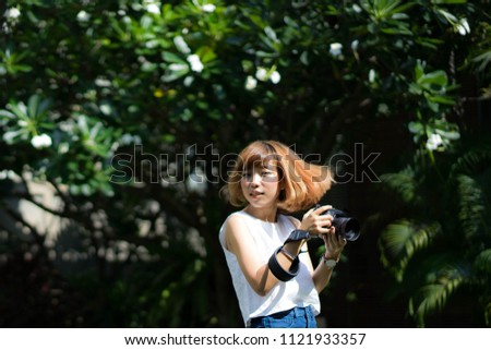 Asian women take a photo in the garden