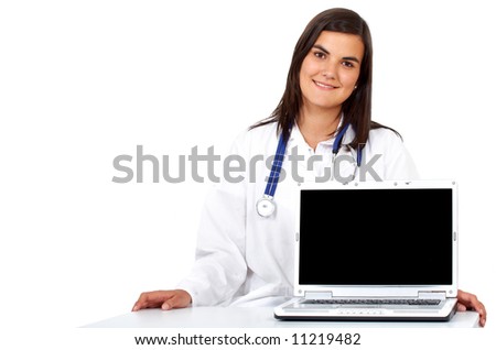 female doctor smiling while displaying a laptop computer isolated over a white background