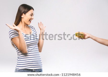 Woman on dieting for good health concept. Woman doing sign yes to refuse junk food or fast food (hamburger and potato fried) that have many fat.