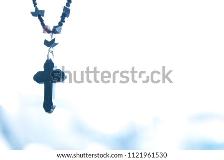 The Christian cross with blurred bokeh light background with morning sunlight, christian concept Jesus is the light of the world, Copy space for design.Blue Tone.