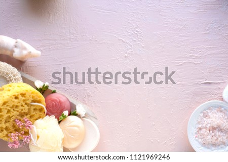 spa accessories and flowers. pink background. Copy space.