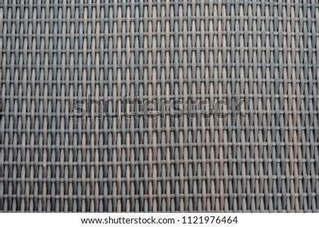Background of brown handicraft weave plastic texture wicker surface for furniture material.plastic weaving texure.