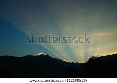 dawn landscape and the first rays of the sun in the dawning sky Royalty-Free Stock Photo #1121985119