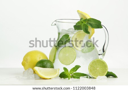 Ice lemonade with lemon, lime and mint on white background.