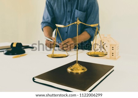 Gold brass balance scale on book with lawyer backgroud, Symbol of law and justice.