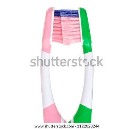 Two toothbrushes green pink macro on white background isolation
