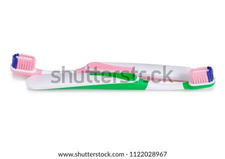 Two toothbrushes green pink on white background isolation