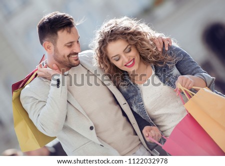Portrait of happy couple with shopping bags.Sale,consumerism and people concept.