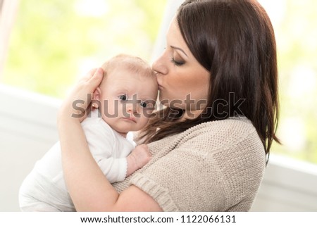 Portrait of happy mother with her cute baby girl