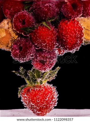 physalis, raspberries and strawberries in sparkling water