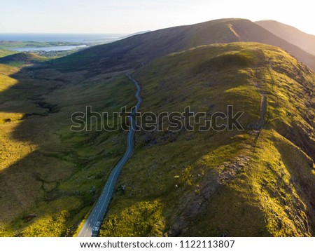 Aerial view of Conor Pass, one of the highest Irish mountain passes served by an asphalted road, located on the south-western end of the Dingle Peninsula, County Kerry, Ireland Royalty-Free Stock Photo #1122113807